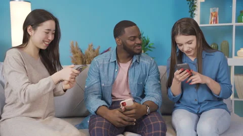 Young people of different races are using phone at home and showing phone. Stock Footage 228801859