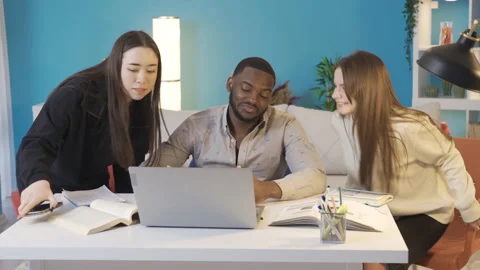 Young people of different races sit at the study desk to study. 스톡 동영상 228803497