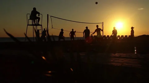 Young people down by the beach playing beach volleyball Video stock 31183498