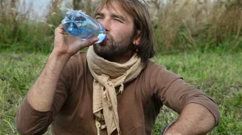 Young people drink clean water from a bottle Stock Footage 8564195