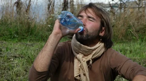 Young people drink clean water from a bottle Stock Footage 8564335