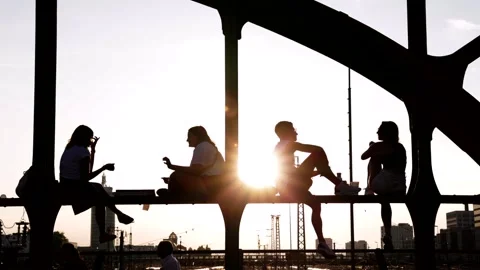 Young people enjoy sunset on Hackerbrücke Munich Germany 2024-08-31 Stock Footage 297631359