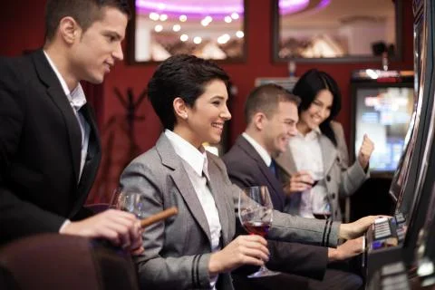 Young people gambling on slot machines Stock Photos