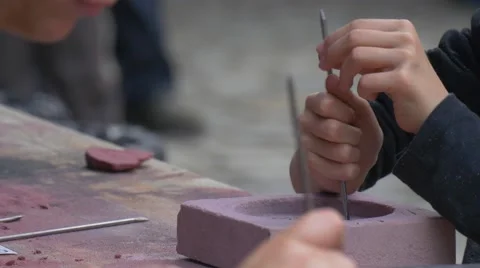 Young People Hands Preparing Casting Molds Stamping With Nails Craftsmen Making Stock Footage 64357940