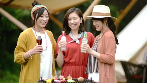 Young people having drinks in front of tent Stock-Footage 160131857