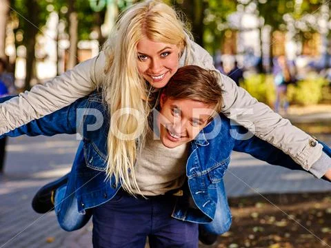 Young people having fun in autumn park. Stock Photos