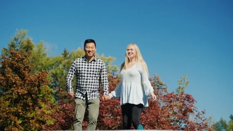 Young people having fun together, jumping high on a trampoline in their backyard Stock Footage 98229324