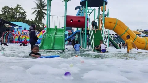 Young people having fun on water slides in aqua park Stock Footage 296662068