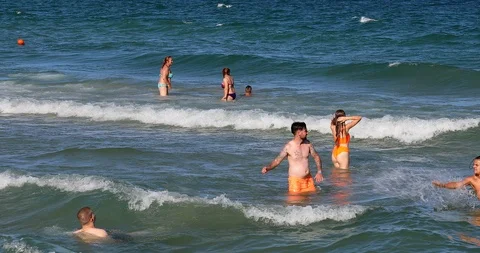 Young People Having Fun In The Waves Video stock 125733802