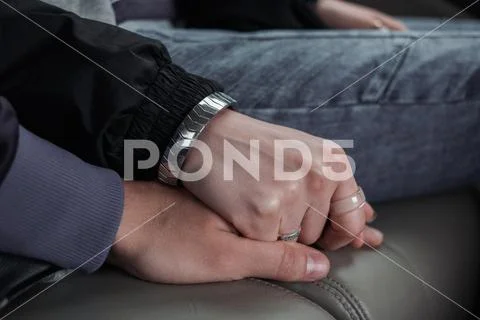 Young people holding hands. support and love. Combat flight anxiety. Stock Photos