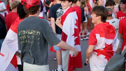 Young people hugging and dancing in street for Canada Day, Kelowna BC Stock Footage 312584392