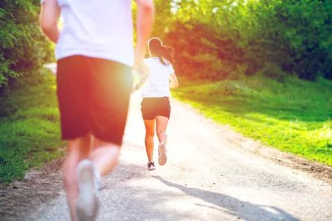 Young people jogging and exercising in nature, Back view Foto stock