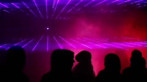Young people jumping and dancing. Light laser show. Night life. Stock Footage