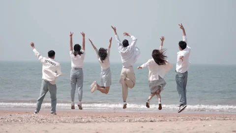 Young people jumping on the beach Video stock 270446150