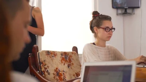 Young people in the loft using a laptop coworking rapid slow motion Stock Footage 84960848