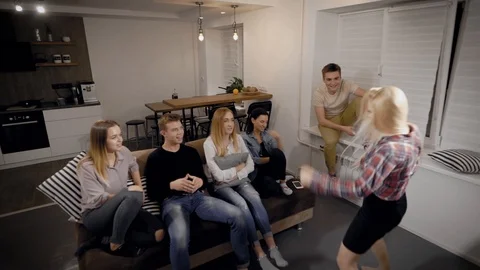 Young people looking at lady explaining something in room Stock Footage 99096557