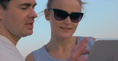 Young people looking at sunset and using pad Stock-Footage 52052016