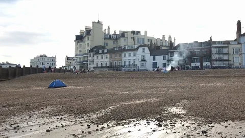 Young people making bbq on a beach in England Stock Footage 115694111