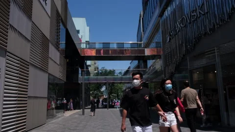 Young people with masks walking in Sanlitun shopping area, Beijing, China. Stock Footage 132024925