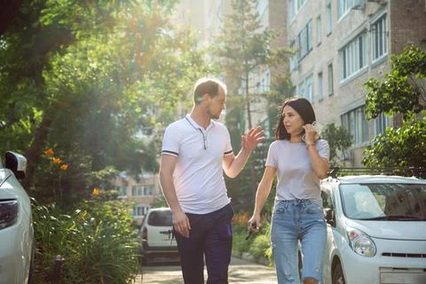 Young people, Millennials, walking down a city street in summer clothes and Stock Photos