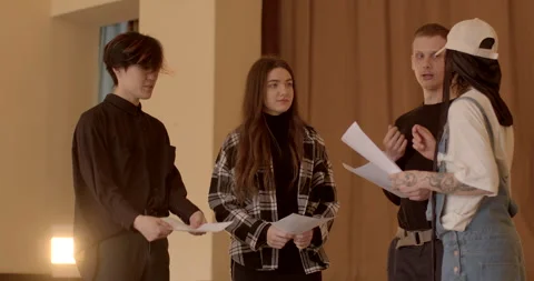 Young people with papers collaborating on a project, preparing a presentation Stock Footage 268090351