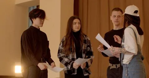 Young people with papers collaborating on a project, preparing a presentation 写真素材