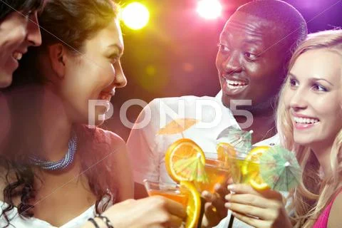 Young people at party drinking martini and communicating Stock Photos