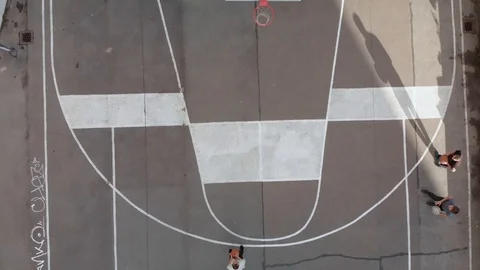 Young people playing basketball from an aerial view as a drone footage Stock Footage