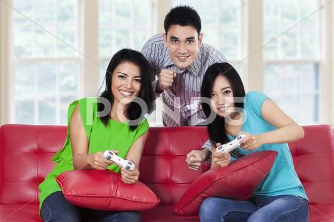 Young People Playing Games At Home