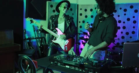 Young people playing music inside a recording studio Stock Footage 153403667