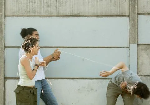 Young people playing with party string Foto stock