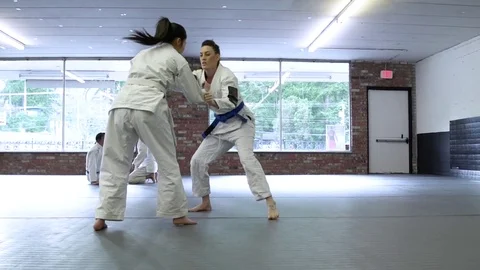Young people practicing Jiu-jitsu in a dojo 動画素材 77093073