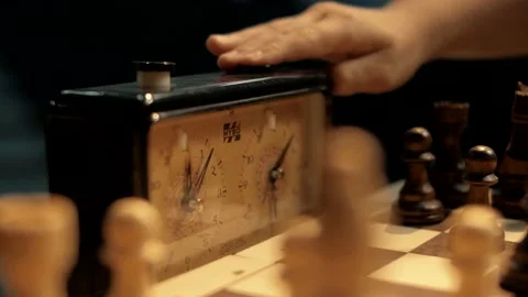 Young people press the chess clock buttons during a game of chess. Stock Footage 156707887