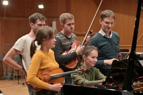 Young people in the process of learning to play stringed instruments Stock Photos