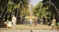 Young people riding bicycles. Men and women strolling, relaxing in summer park HD Footage