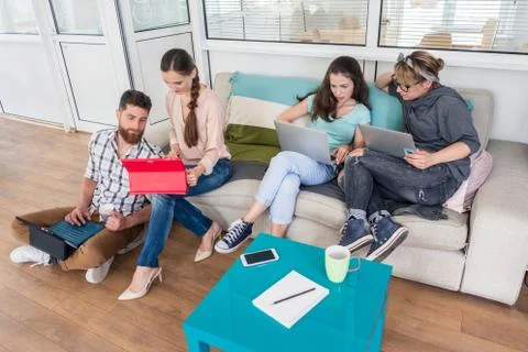 Young people sharing a collaborative office space in a modern hub Stock Photos