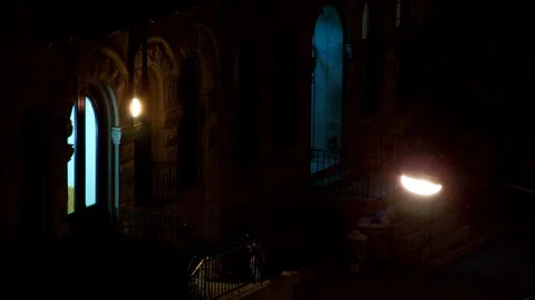 Young people sitting on stoop outside apartment building, night. Video stock 106259996