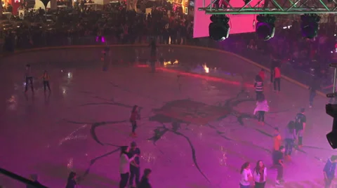 Young people skating on a mall ice rink, disco lights, fun, sport, indoors Stock Footage 33072838