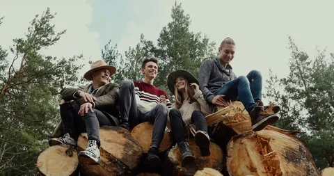 Young people on stack of logs Video stock 94553696