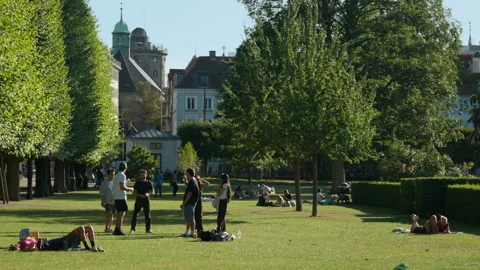 Young people stand and chat on the lawn in Kings Garden park in Copenhagen Vídeo Stock 344849618