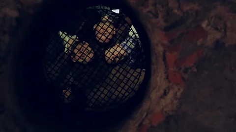 Young people talking through the bars. Prison, museum, quest. Exploring the Stock-Footage 105271969