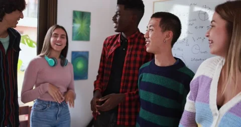 Young people talking together inside classroom Stock Footage 164378237