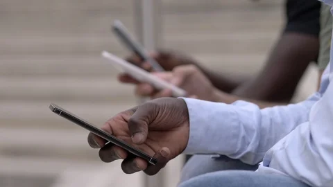 Young people, technology, communication. black white hands typing on smartphones Stock Footage 92390971