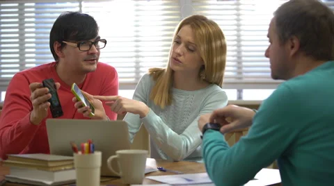 Young people using different electronic gadgets and talking in the office. 4k. Stock Footage 60568425