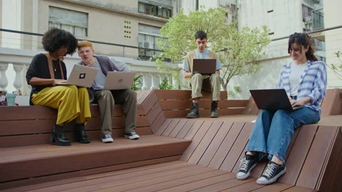Young People Using Laptops and Working Remotely Outdoors in the City Stock Footage 243949289