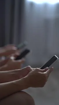 Young people using mobile devices together, illustrating technology addicti.. Stock Photos