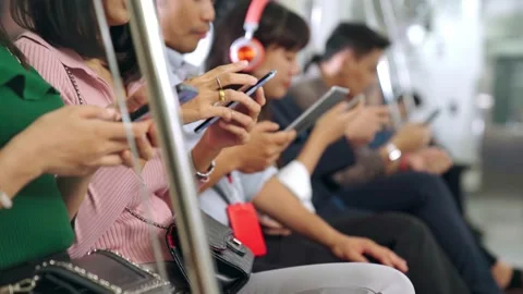 Young people using mobile phone in public underground train Stock Footage 140929775