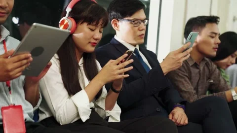 Young people using mobile phone in public underground train Stock Footage 141376480