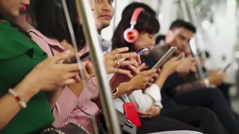 Young people using mobile phone in public underground train Stock Footage 146398514