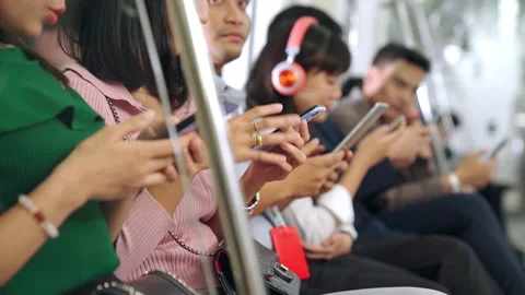 Young people using mobile phone in public underground train Stock Footage 148891675